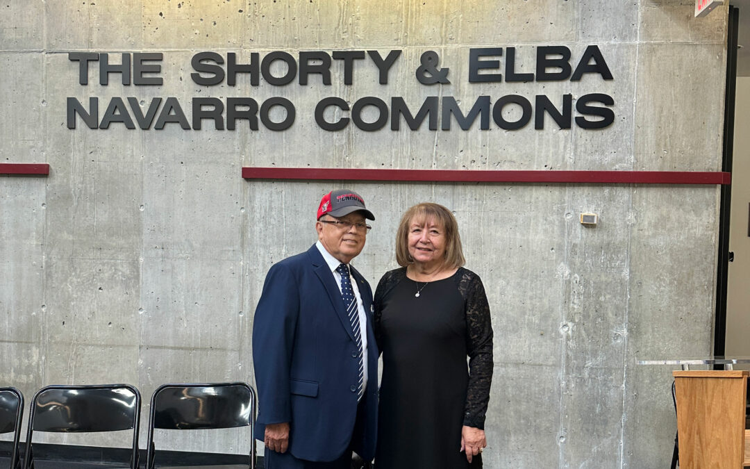 Shorty and Elba Navarro standing in front of a sign that reads "The Shorty and Elba Navarro Commons"