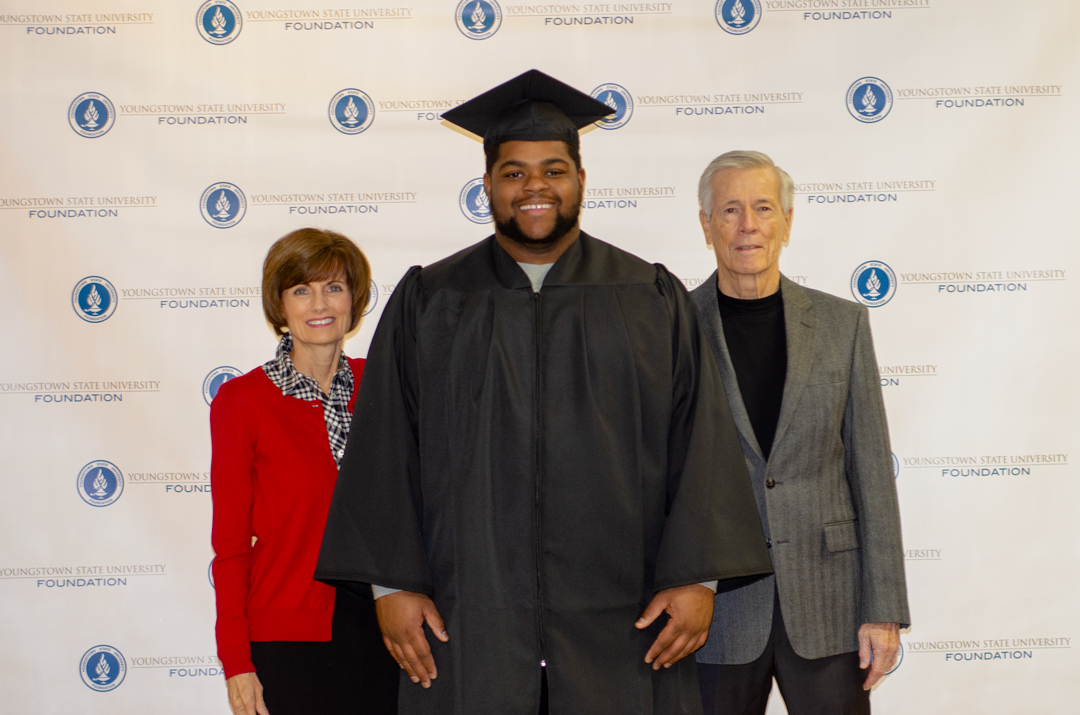 Photo of donors with a graduating scholarship recipient